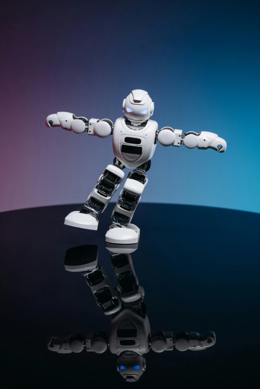 a white robot standing on a black surface
