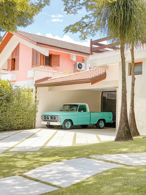 a green truck parked in front of a house, a colorized photo, by Felipe Seade, pexels contest winner, pop art, pastel pink concrete, classic car, tropical color scheme, profile image