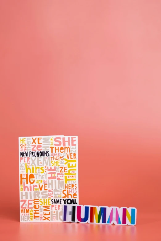 a book sitting on top of a table next to a pile of letters, an album cover, by Ellen Gallagher, shutterstock contest winner, pink and orange colors, hey, men and women, greeting card