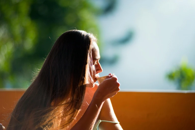 a woman sitting at a table eating food, by Eglon van der Neer, pexels contest winner, sun glare, profile image, panoramic view of girl, thoughtful )