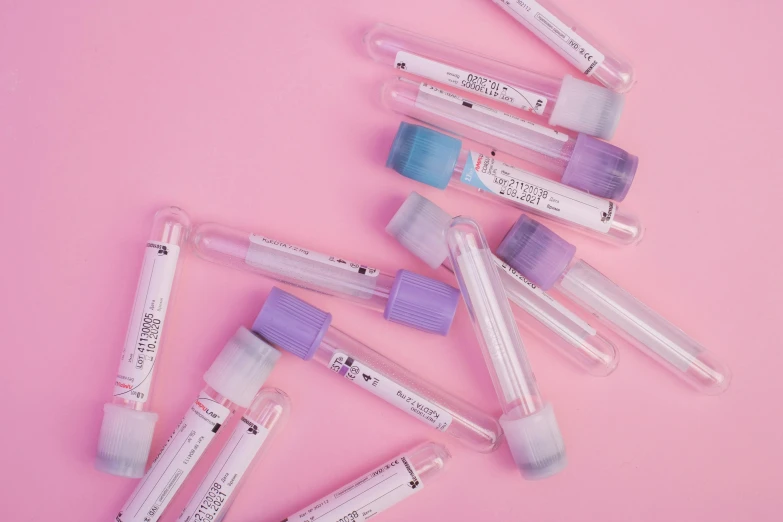 a bunch of vials sitting on top of a pink surface, medical labels, cold hue's, iv pole, thumbnail