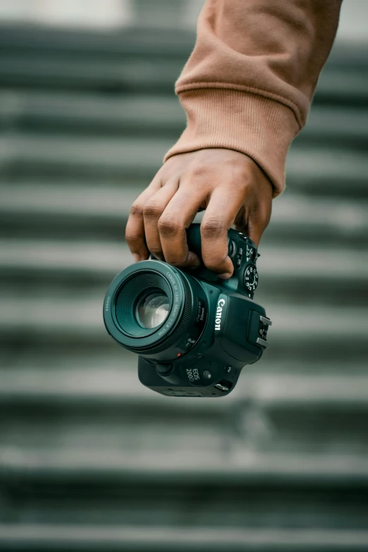 a person holding a camera in their hand, pexels contest winner, crawling towards the camera, professional color photography, towering over the camera, hands