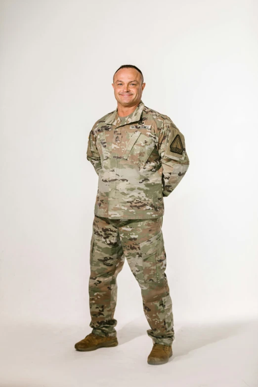 a man in a military uniform posing for a picture, zoomed out full body, multicam camo, vp of marketing, on clear background