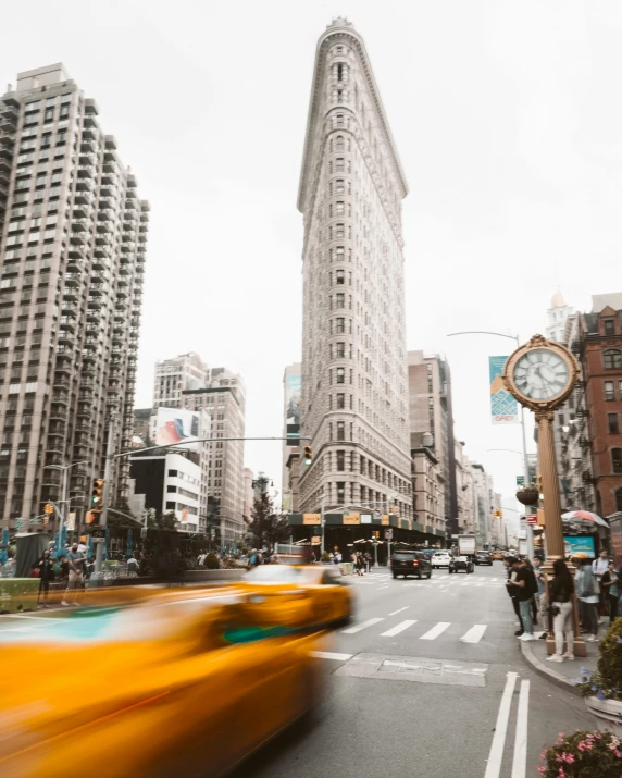 a yellow taxi driving down a street next to tall buildings, unsplash contest winner, art nouveau, humans of new york, thumbnail, lgbtq, background image