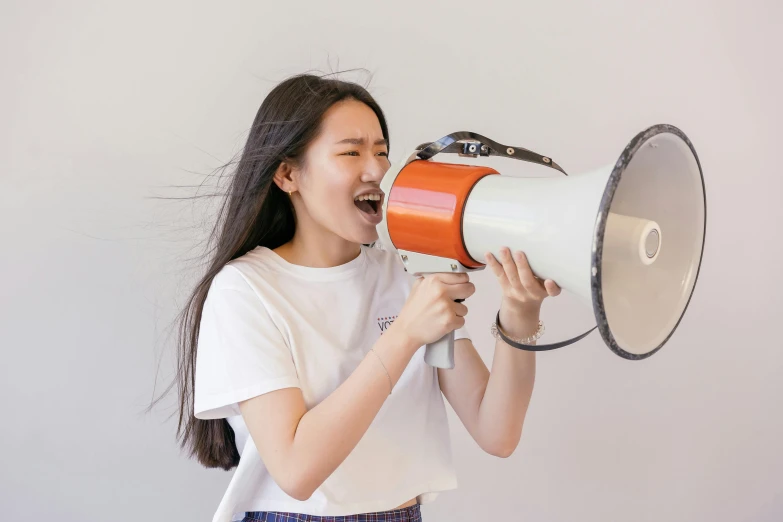 a woman screaming with a megaphone in her hand, pexels contest winner, hyperrealism, young asian girl, avatar image, giant speakers, official product photo