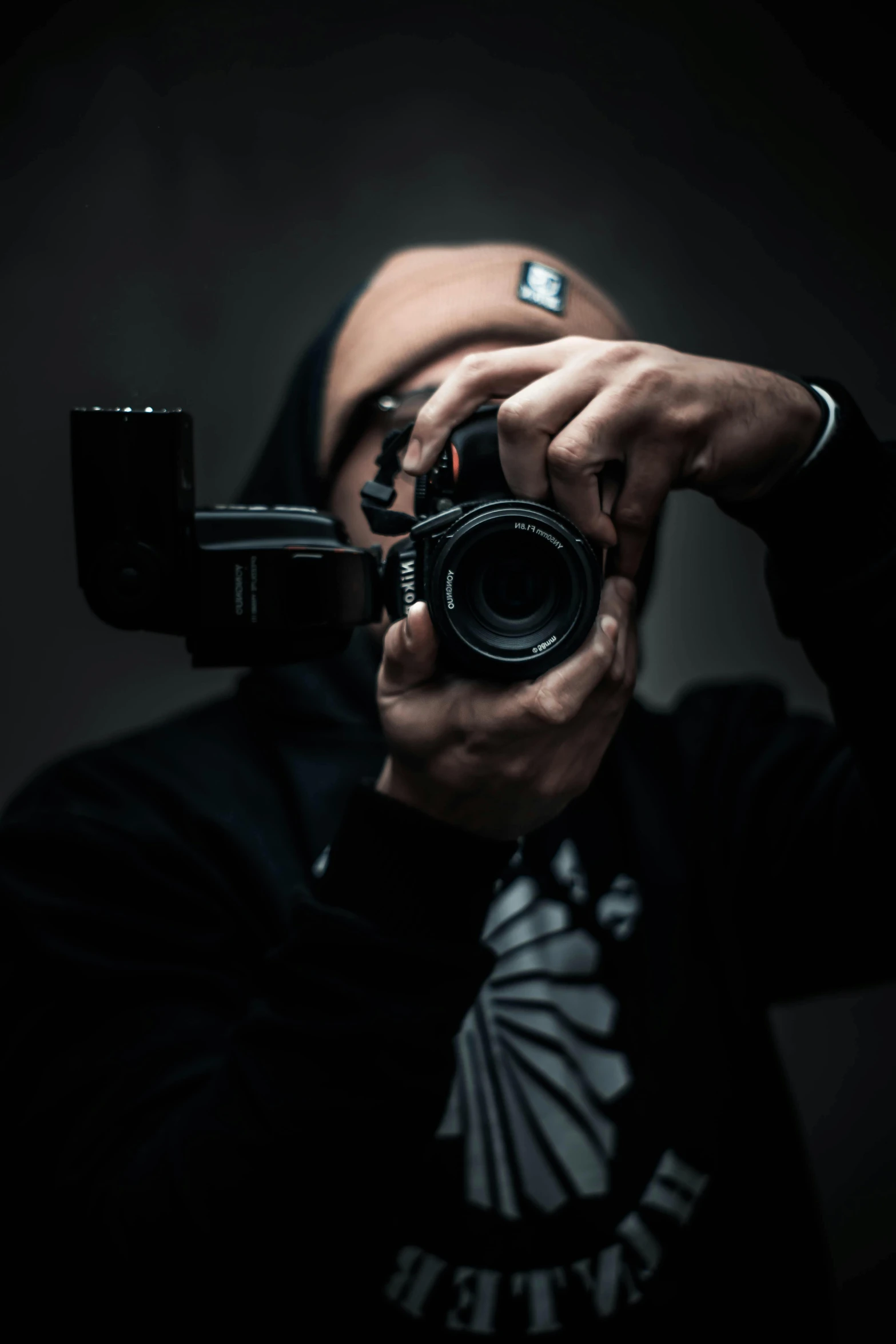 a man taking a picture with a camera, by Adam Marczyński, dark backround, low quality photograph, spying, professional photo-n 3