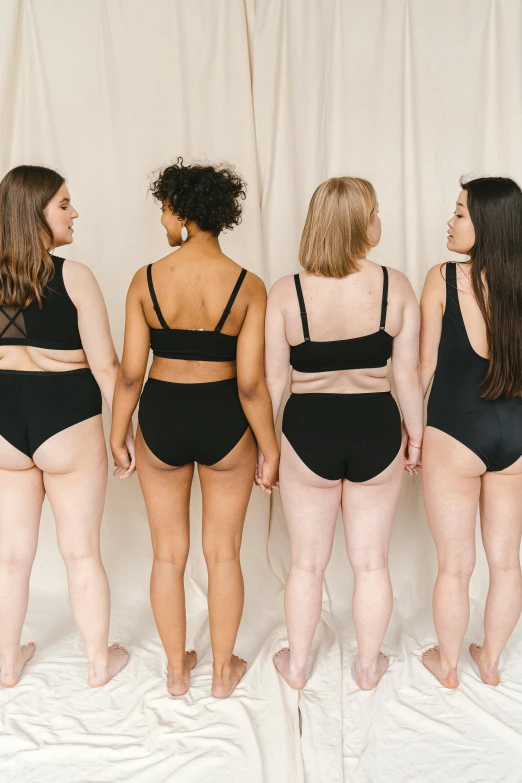 a group of women standing next to each other, inspired by Vanessa Beecroft, trending on pexels, renaissance, black underwear, shapely toned derriere, is wearing a swimsuit, measurements