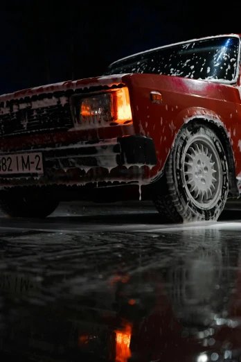 a red car is parked in the snow, dark glowing rain, water-cooled, production photo, lada