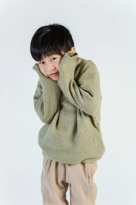 a young boy in a green sweater and khaki pants, by Miyamoto, instagram, wearing an oversized sweater, product introduction photo, kami, young girl