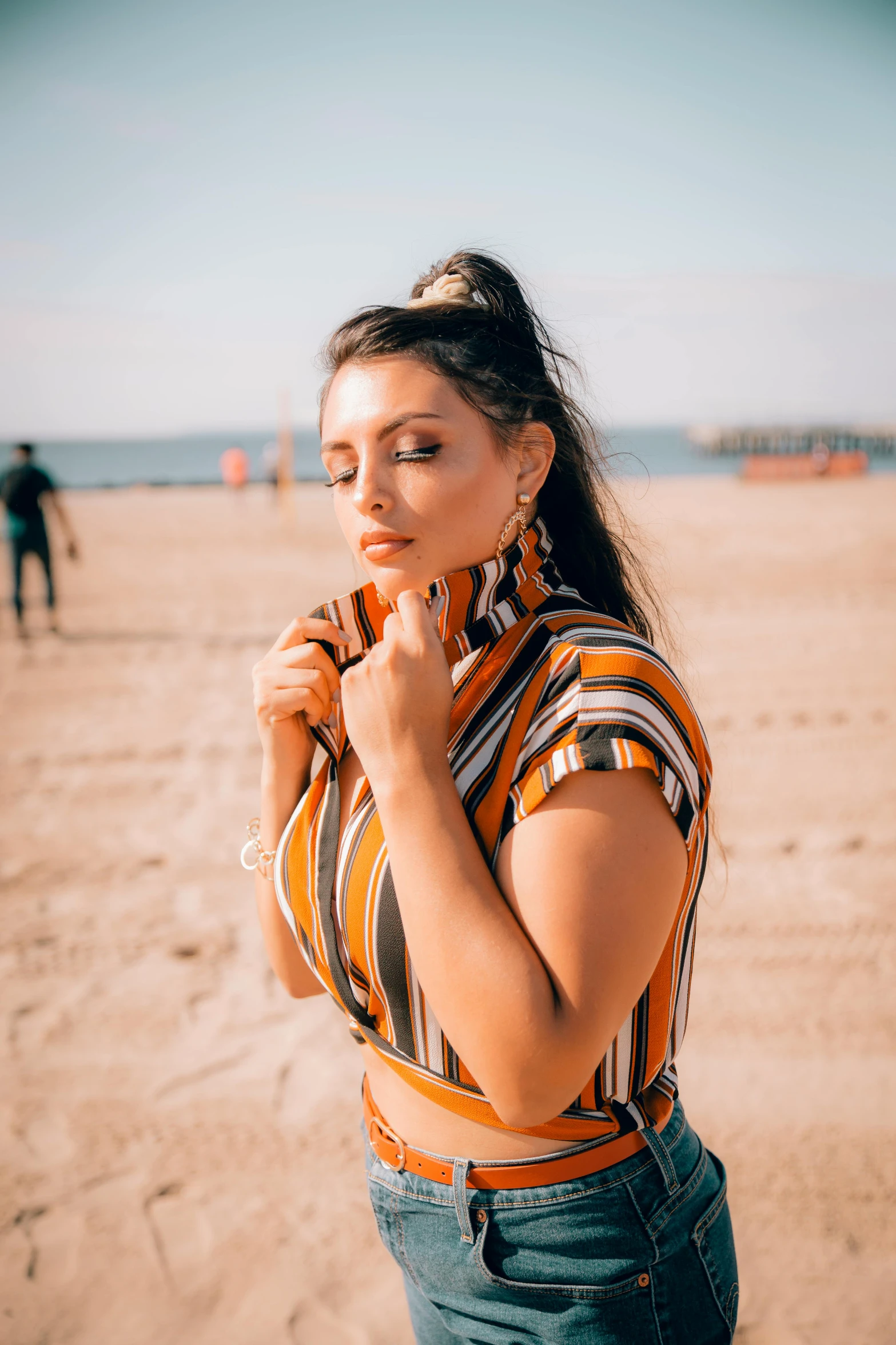 a woman standing on top of a sandy beach, trending on pexels, renaissance, portait of haifa wehbe, wearing stripe shirt, double chin, indian girl with brown skin