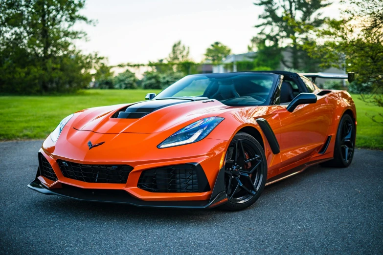 an orange sports car parked on the side of the road, by Matt Cavotta, pexels contest winner, full front view, avatar image, gm, instagram post