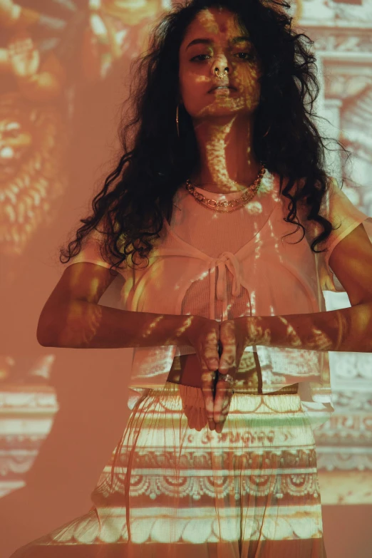 a woman standing in front of a projector screen, an album cover, trending on pexels, renaissance, hindu god, double exposure portrait, intricate white and gold neon, hands