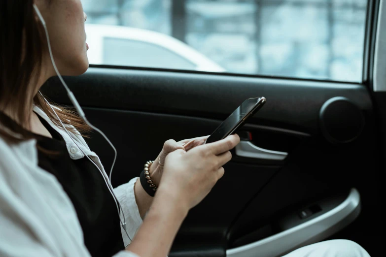 a woman sitting in a car looking at her cell phone, trending on pexels, square, corporate phone app icon, 1 5 0 4, blank