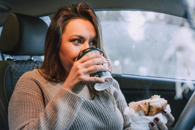 a woman sitting in a car drinking a cup of coffee, a portrait, trending on pexels, taco bell, avatar image, freezing, anna nikonova aka newmilky