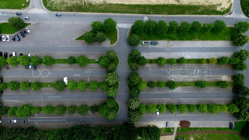 a bird's eye view of a city street, by Adam Marczyński, pexels contest winner, realism, green trees, parking lot, in a row, berlin park