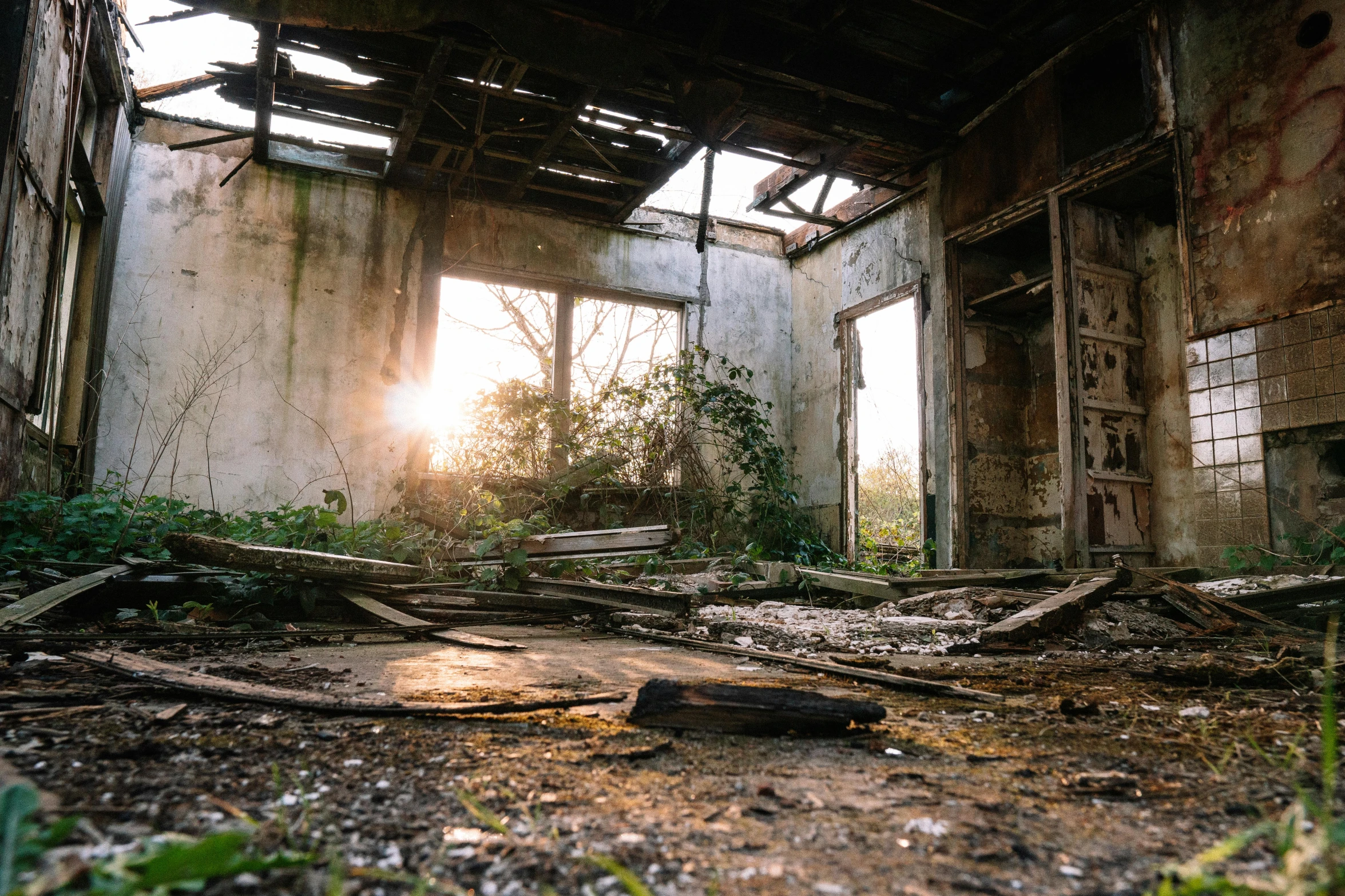 the sun shines through the window of an abandoned building, an album cover, unsplash contest winner, debris on ground, apocalypse with vegetation, smoke filled room, taken in the early 2020s