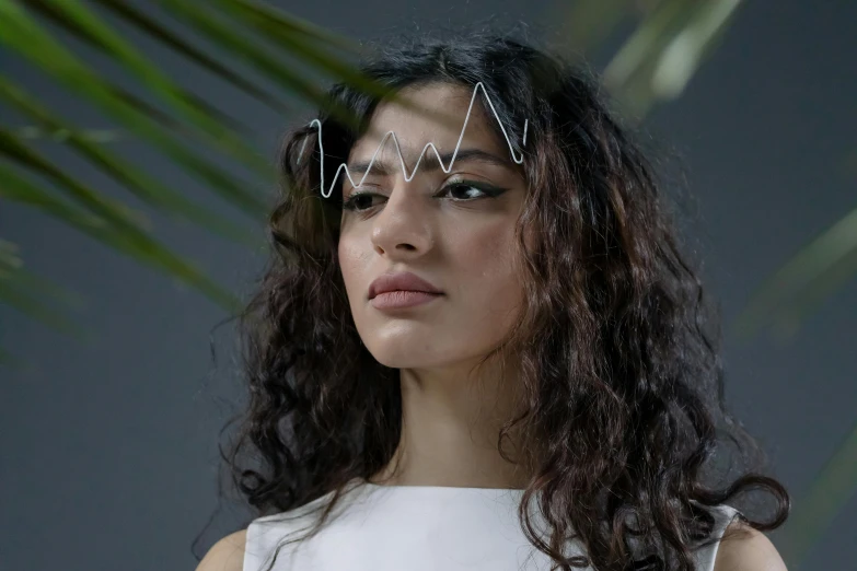 a woman standing in front of a palm tree, by Emma Andijewska, kinetic art, tiara, silver，ivory, trending on dezeen, wavy