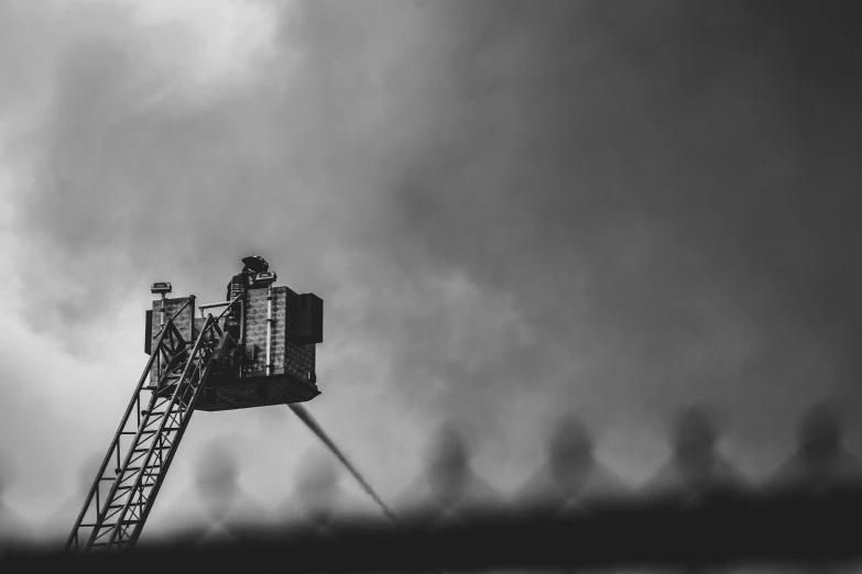 a black and white photo of a fire truck, by Adam Marczyński, pexels contest winner, figuration libre, sitting in a crane, toxic clouds, standing on a ladder, closeup photo