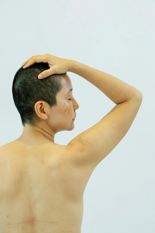 a man that is standing in front of a mirror, inspired by Zhang Kechun, hyperrealism, showing her shoulder from back, scratching head, tan complexion, partially cupping her hands