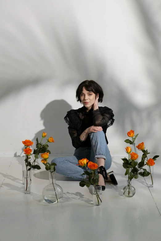 a woman sitting on the ground surrounded by vases of flowers, an album cover, by Winona Nelson, alice cullen, high-quality photo, growing out of a giant rose, sun yunjoo