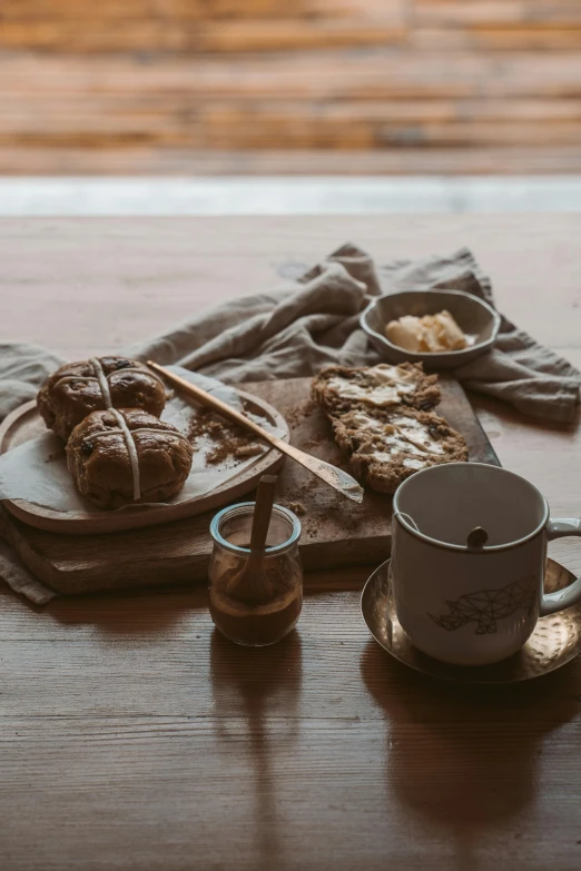 a close up of a plate of food on a table, a still life, pexels contest winner, bakery, cozy environment, brown, scandinavian