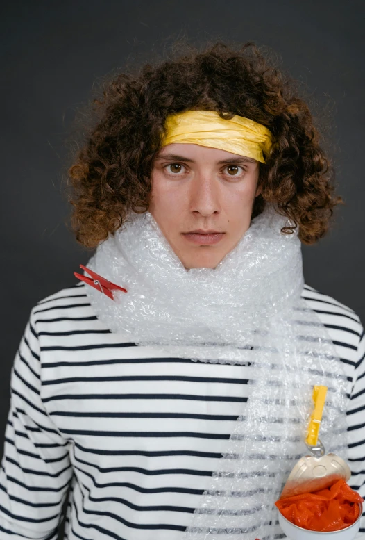 a man with curly hair holding a bowl of carrots, an album cover, inspired by Andrea del Verrocchio, plasticien, subject made of white mesh rope, teenage no, wearing a lemon, pirate