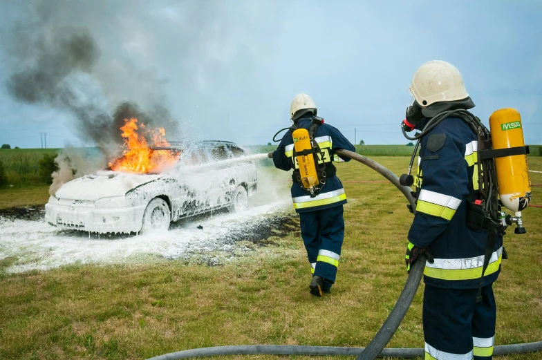 two firefighters are trying to put out a car fire, by Daniel Lieske, pexels contest winner, avatar image, print ready, hsv, thumbnail