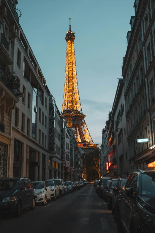 the eiffel tower towering over the city of paris, an album cover, unsplash contest winner, narrow and winding cozy streets, late evening, 2019 trending photo, northern france