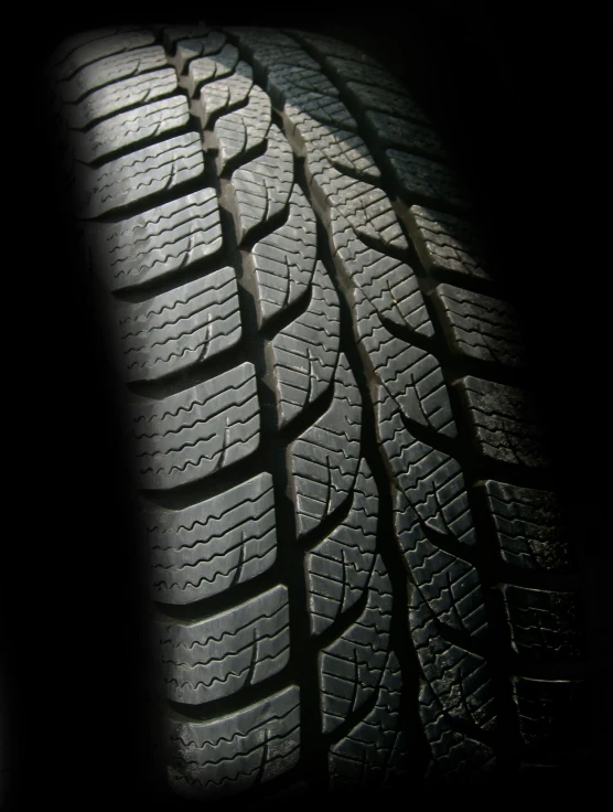 a close up of a tire in the dark, winter sun, thumbnail, hyperdetailed, hires