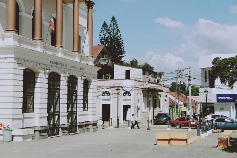 a dog sitting on a bench in front of a building, by Emma Andijewska, unsplash, quito school, driving through a 1 9 5 0 s town, transylvania, background image, train station in summer