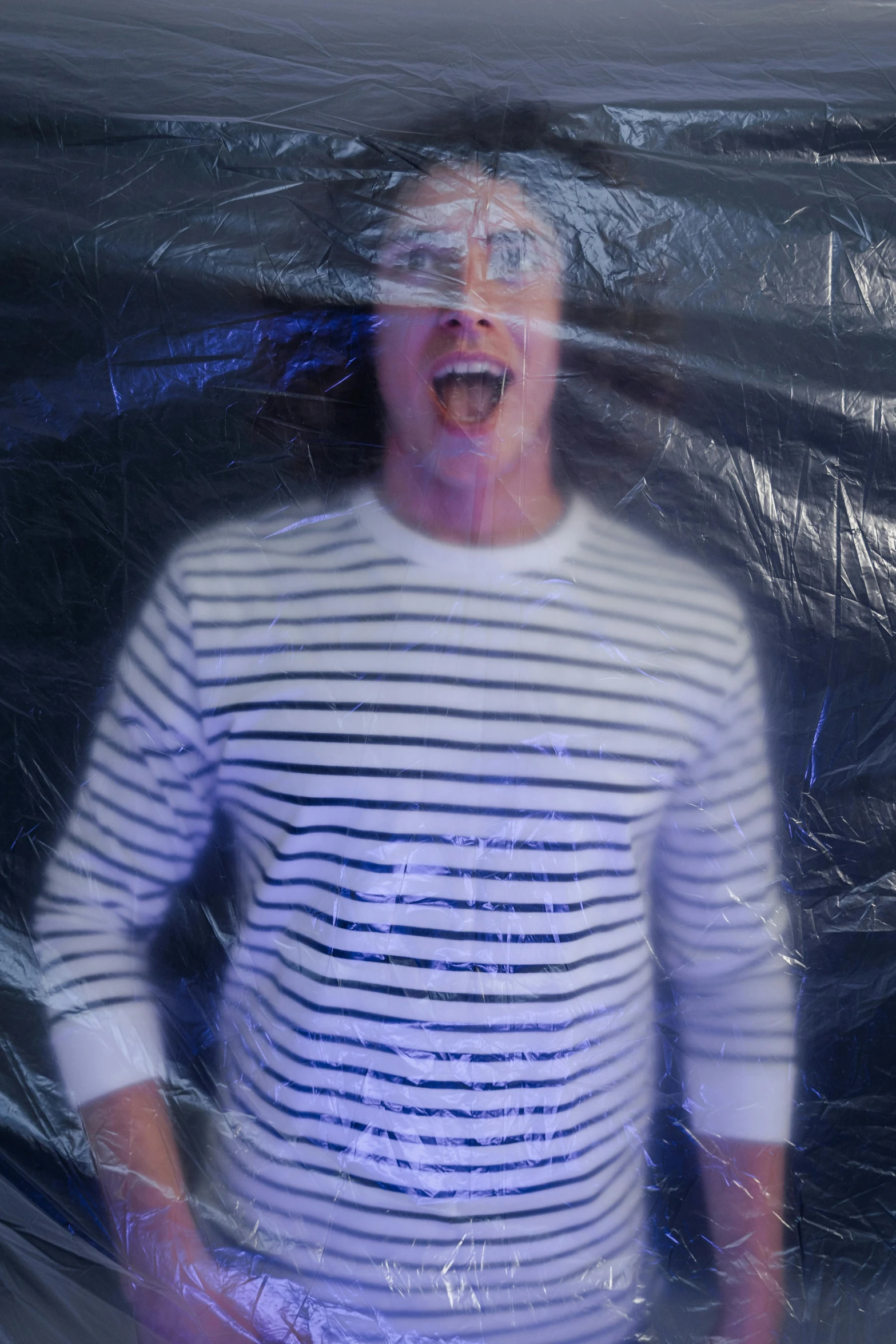 a man standing inside of a plastic bag, an album cover, inspired by Max Gubler, unsplash, happening, screaming with fear, striped, jc park, movie still