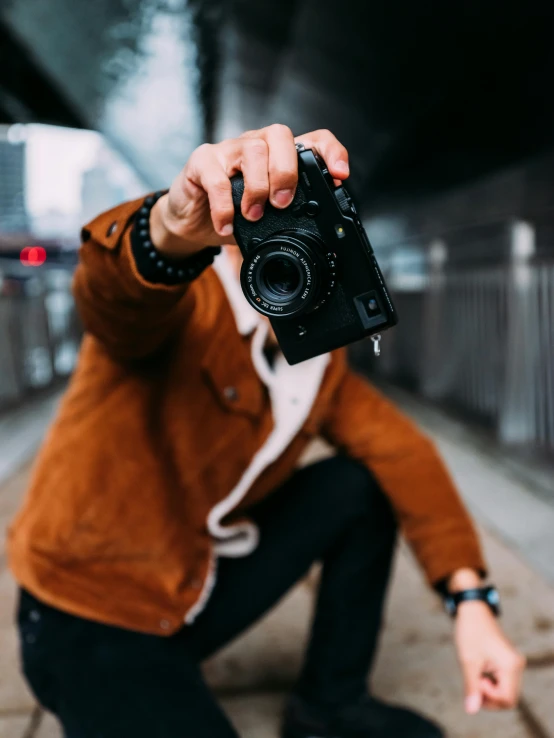 a man taking a picture with a camera, unsplash contest winner, model posing, wave a hand at the camera, a man wearing a black jacket, today\'s featured photograph 4k