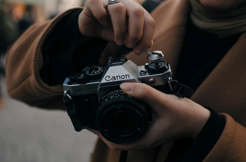 a close up of a person holding a camera, a picture, unsplash contest winner, canon a1, instagram post, colour photo, [ realistic photography ]