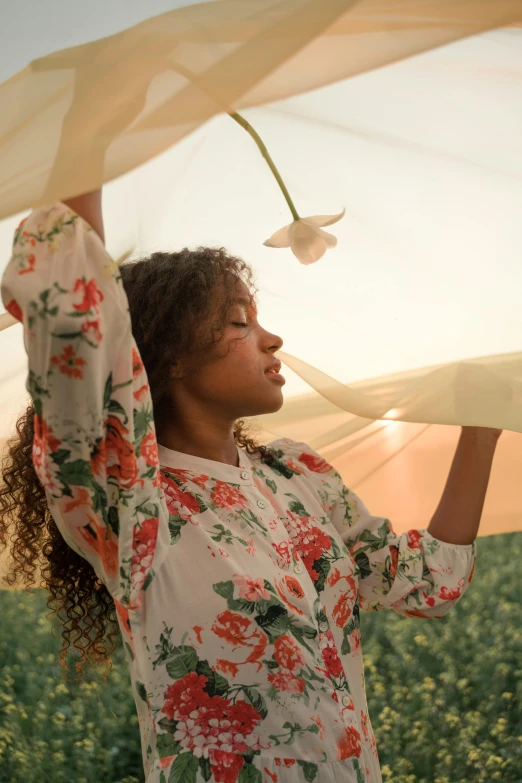 a woman standing in a field holding an umbrella, trending on unsplash, renaissance, floral clothes, in bloom greenhouse, imaan hammam, draped in flowing fabric