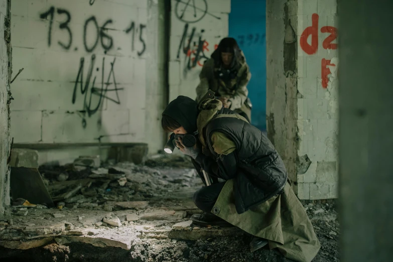 a couple of men standing next to each other in a building, inspired by Elsa Bleda, pexels contest winner, graffiti, troops searching the area, wearing apocalyptic clothes, they are crouching, production still