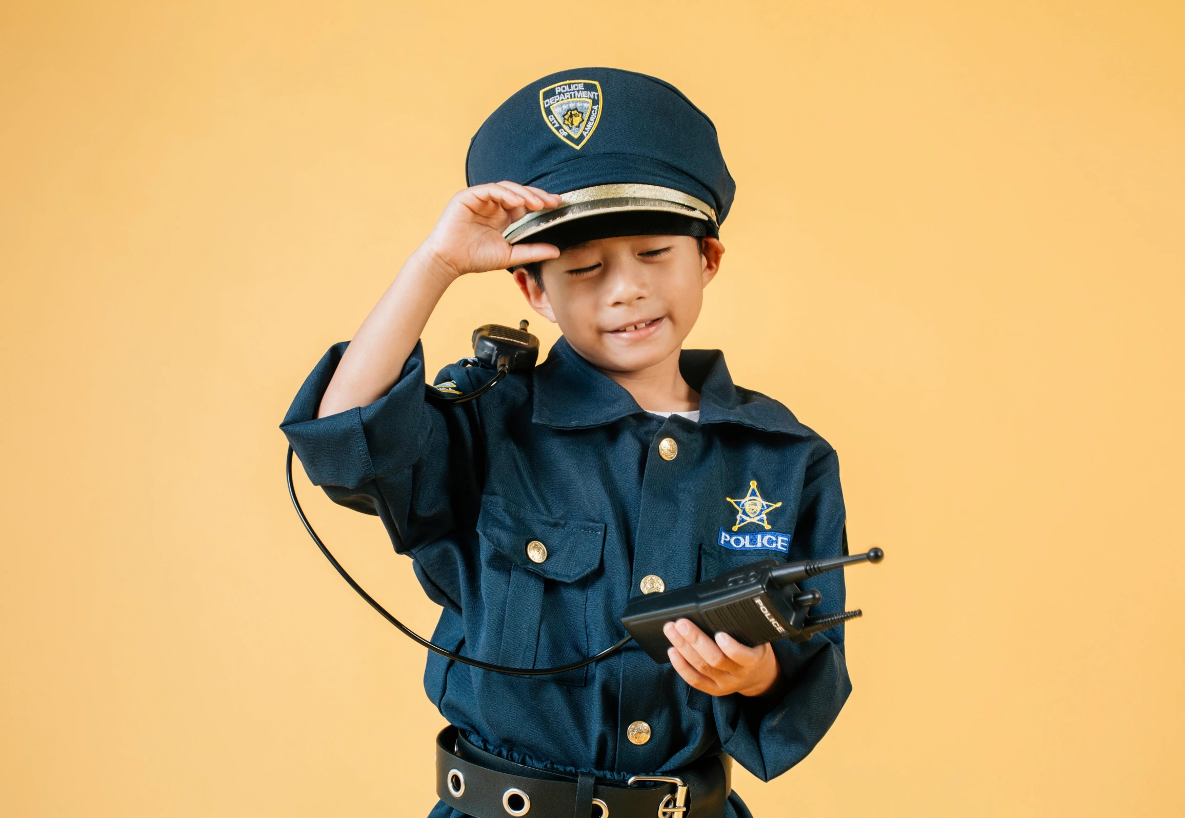 a little boy dressed up as a police officer, a cartoon, trending on pexels, cosplay photo, épaule devant pose, handheld, diverse