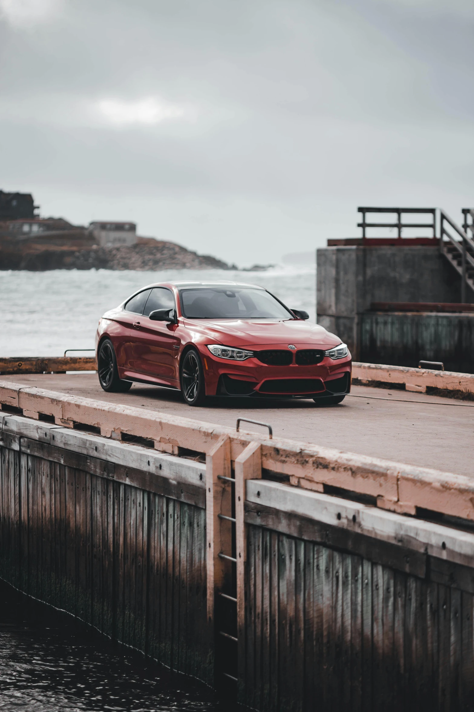 a red car parked on a dock next to a body of water, by Tom Bonson, pexels contest winner, renaissance, bmw, aggressive pose, san francisco, 15081959 21121991 01012000 4k