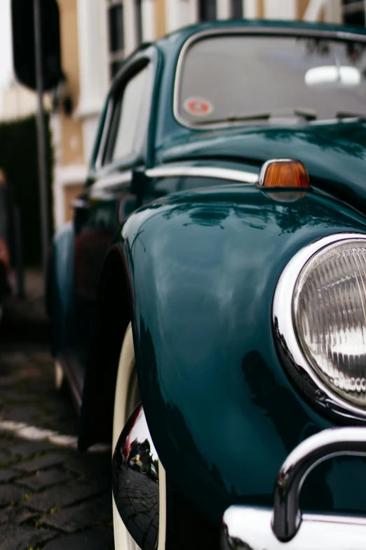 a close up of a car parked on a street, by Sven Erixson, pexels contest winner, scarab, side light, classic chrome, low quality photo