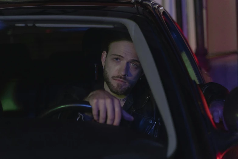 a man sitting in the driver's seat of a car, a portrait, by Elsa Bleda, shutterstock, pete davidson, night time footage, ad image, annoyed