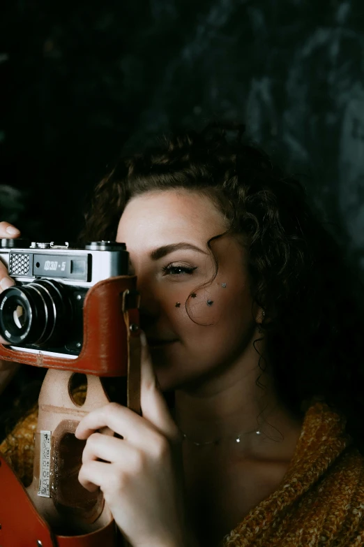 a woman taking a picture of herself with a camera, inspired by Elsa Bleda, pexels contest winner, lovingly looking at camera, old style photo, attractive photo, scratches on photo