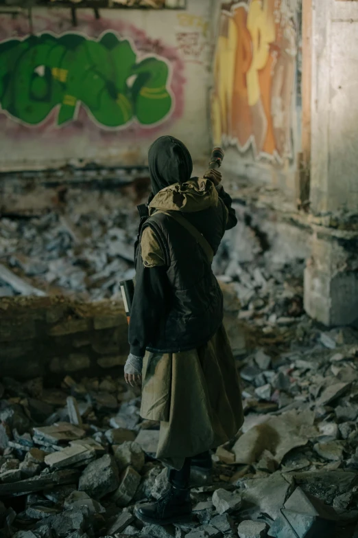 a person standing in a room with graffiti on the walls, post apocalyptic attire, islamic, long shot from back, gen z