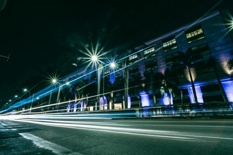 a long exposure photo of a city street at night, blue accent lighting, singapore esplanade, event photography, vehicle photography