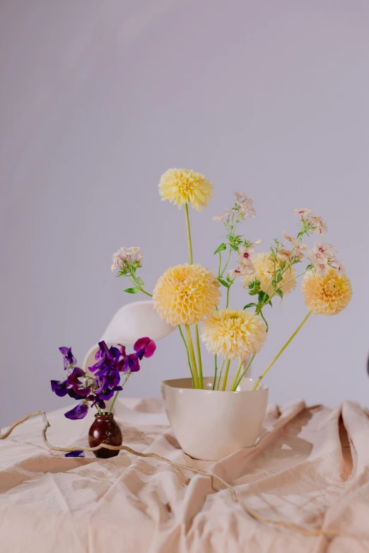 a couple of vases sitting on top of a table, yellow and purple color scheme, soft details, whimsy, full product shot