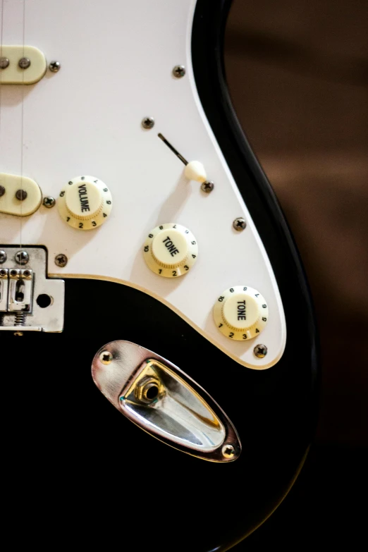 a close up of a guitar with dice on it, by Dave Melvin, pexels contest winner, fender stratocaster, electrical details, on display, dials