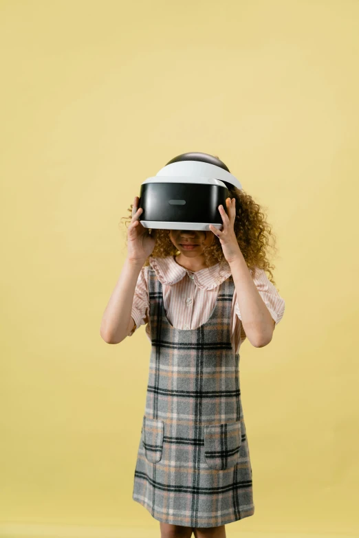 a little girl wearing a virtual reality headset, an album cover, by Carey Morris, unsplash, hypermodernism, full body close-up shot, nerd, professional product photo, concern