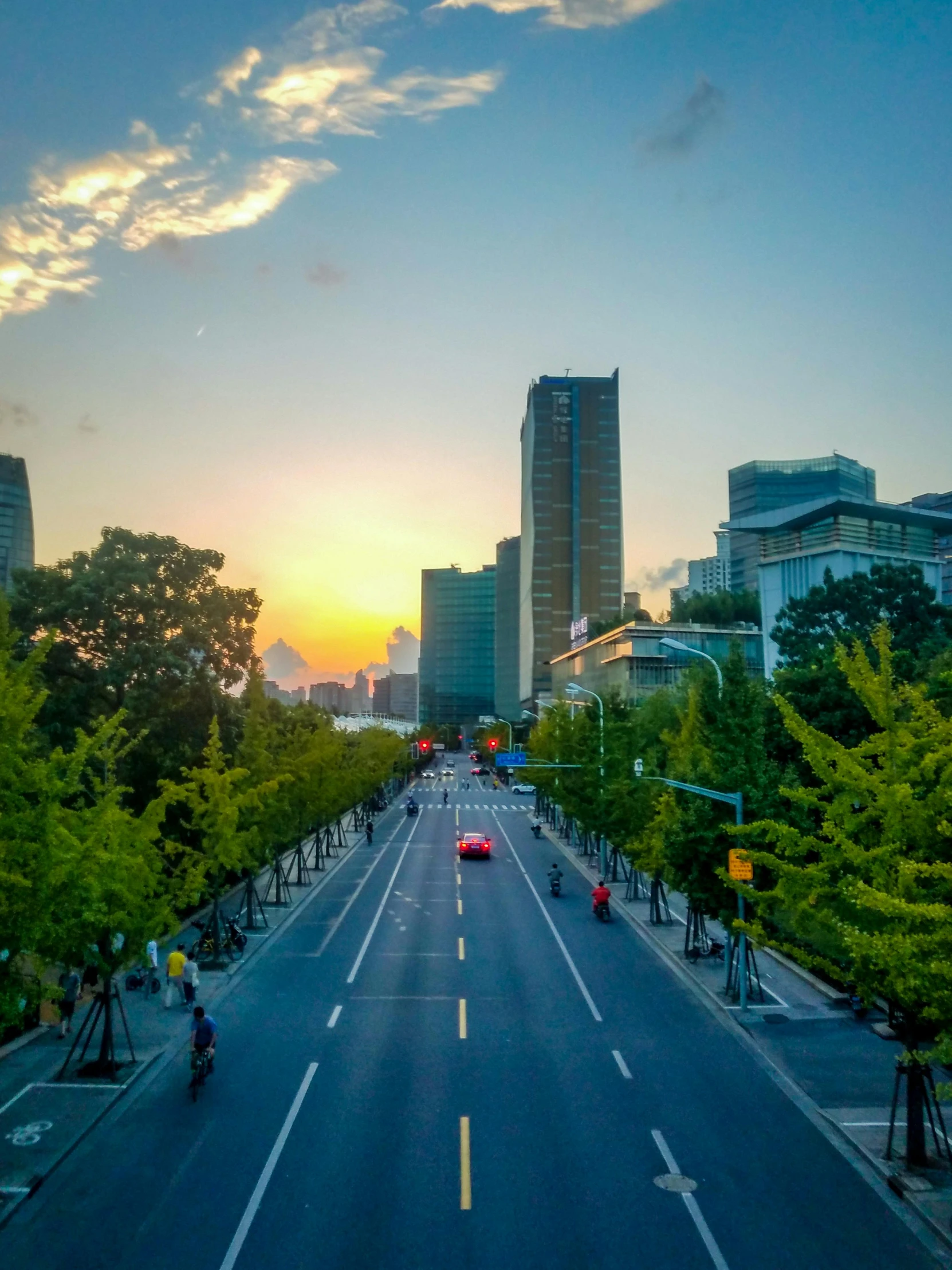 a street filled with lots of traffic next to tall buildings, a picture, inspired by Miyagawa Chōshun, pexels contest winner, realism, tree-lined path at sunset, gwanghwamun, today\'s featured photograph 4k, toronto city