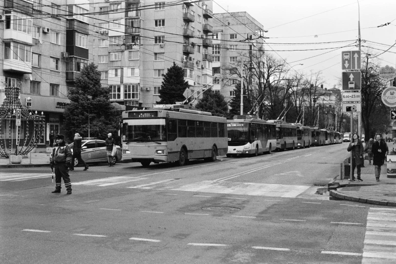 a black and white photo of a city street, a picture, by Zoltán Joó, flickr, realism, buses, romanian, 🐝👗👾, square