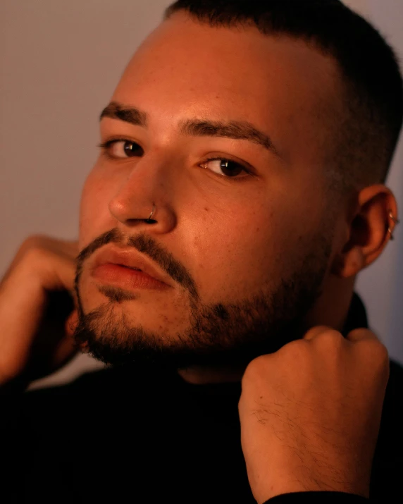 a man with a beard wearing a black shirt, an album cover, inspired by Robbie Trevino, an epic non - binary model, mixed race, profile image, lovingly looking at camera