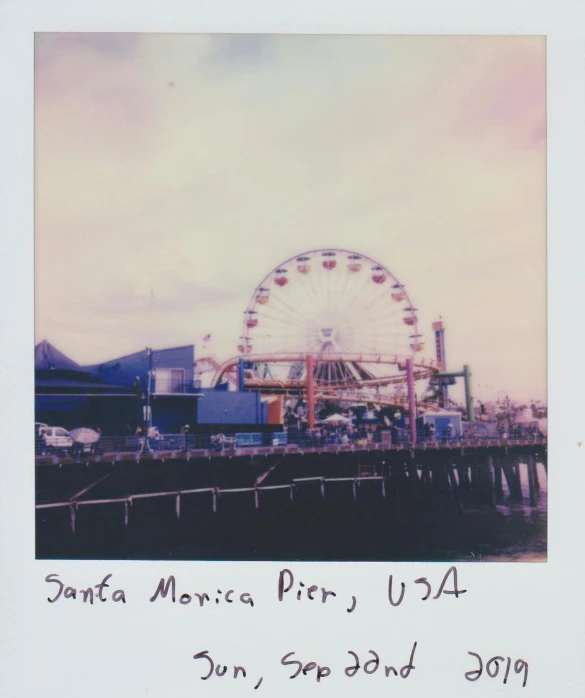 a ferris wheel sitting on top of a pier, a polaroid photo, los angelos, 9 4, ansel ], photograph