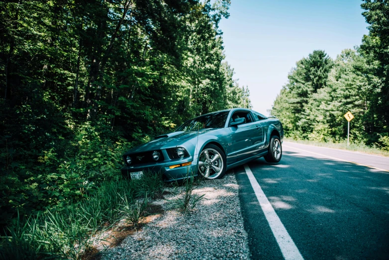 a car that is sitting on the side of the road, by Carey Morris, pexels contest winner, mustang, william penn state forest, avatar image, 🚿🗝📝